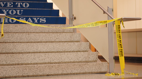 Police tape blocks off the stairway to the second floor of Duques Hall.
