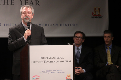 Teacher Timothy Bailey speaks after being awarded the National History Teacher of the Year award at The School Without Walls Tuesday. U.S. Secretary of Education Arne Duncan, right, was on hand to congratulate him.
