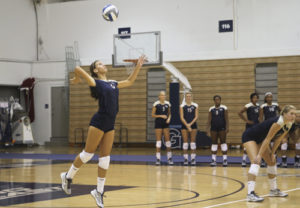 Freshman Setter Emily Clemens serves the ball inthe Colonials' loss against Georgetown earlier this season. Cameron Lancaster | Contributing Photo Editor