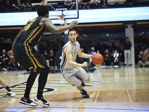 Freshman guard Miguel Cartagena looks to go around a VCU defender earlier this month. Cameron Lancaster | Assistant Photo Editor