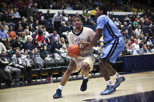 Sophomore Kethan Savage drives past a Rhode Island defender. Hatchet File Photo by Cameron Lancaster | Assistant Photo Editor