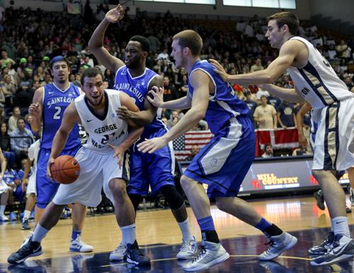 Then-freshman forward Kevin Larsen battles a tough Saint Louis defense at the Smith Center last year. Hatchet File Photo by  Cameron Lancaster 