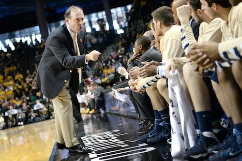 Head coach Mike Lonergan talks to the men's basketball team during the A-10 Tournament last season. Hatchet File Photo