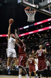 Sophomore Kevin Larsen goes for the jump hook over a Massachusetts defender in Friday's A-10 Quarterfinal win. | Photo Editor Sam Klein