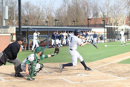 Then-senior Owen Beightol hits in GW's win against George Mason last season. File Photo by Zach Montellaro | Hatchet Staff Photographer