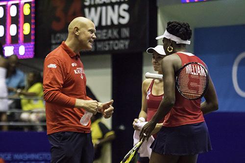 Coach Murphy Jensen talks to players Venus Williams and Martina Hingis. The two former rivals would team up in the women's doubles set, winning 5-2. Zach Montellaro | Hatchet Staff Photographer