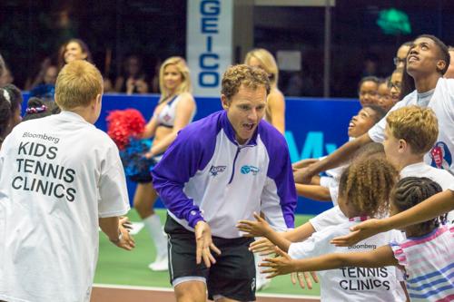 Michael Russell of the Springfield Lasers high-fives local children during prematch introductions. Zach Montellaro | Hatchet Staff Photographer