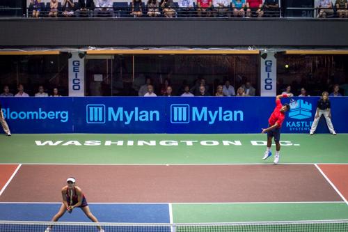 Leander Paes serves the ball over his partner Martina Hingis. They won the mixed doubles set 5-2. Zach Montellaro | Hatchet Staff Photographer