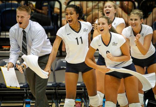 The volleyball's bench cheers after winning a point over Auburn on Friday. Hatchet File Photo by Andrew Goodman | Hatchet Staff Photographer