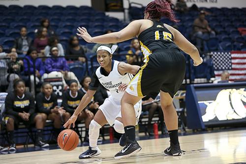 Senior Chakecia Miller drives past a defender in a game earlier this season. File Photo by Dan Rich | Hatchet Photographer