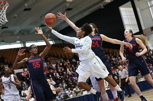 Senior guard Lauren Chase reels in the ball in a game earlier this season. Chase scored 16 points and dished out five assists as the Colonials took control in overtime at Richmond Thursday to win 81-69. Dan Rich | Hatchet Photographer