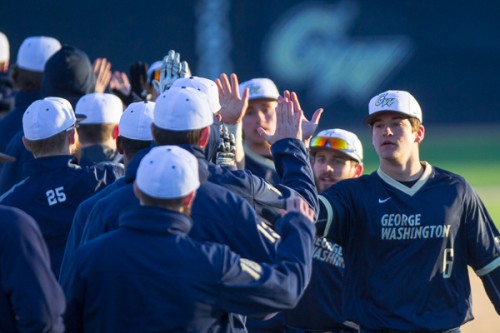 The Colonials celebrate a victory earlier in the season. GW avoided a season sweep to UMES on Wednesday, winning 10-1 on the road. File Photo by Zach Montellaro | Hatchet Staff Photographer