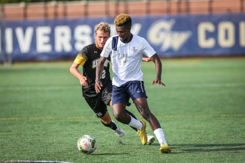 Sophomore midfielder Koby Osei-Wusu pushes the ball in a game earlier this season. Hatchet File Photo by Dan Rich | Contributing Photo Editor