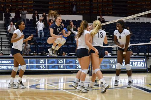 The Colonials celebrate their five set victory over American on Wednesday night. Camille Ramasastry | Hatchet Photographer