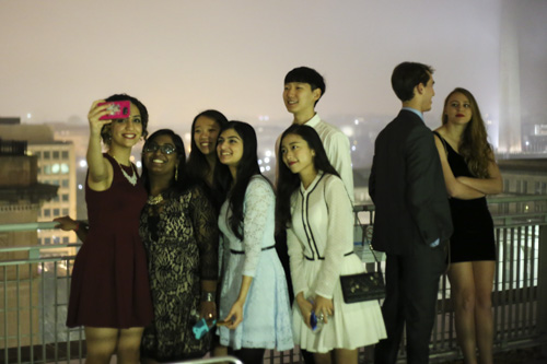 Students pose for a photo on the balcony outside the City View Room during the College Democrats' ball Saturday. Keegan Mullen | Hatchet Photographer