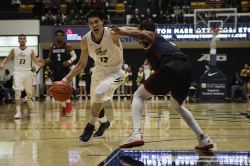 Junior guard Yuta Watanabe drives the ball to the hoop against Duquesne on Wednesday. He led GW with 15 points during the team's win. Ethan Stoler | Hatchet Photographer