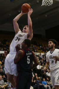 Graduate student forward Tyler Cavanaugh goes up to the rim against Duquesne last week. The team's leading scorer will look to guide GW to a road win at George Mason Wednesday. Ehtan Stoler | Hatchet Photographer